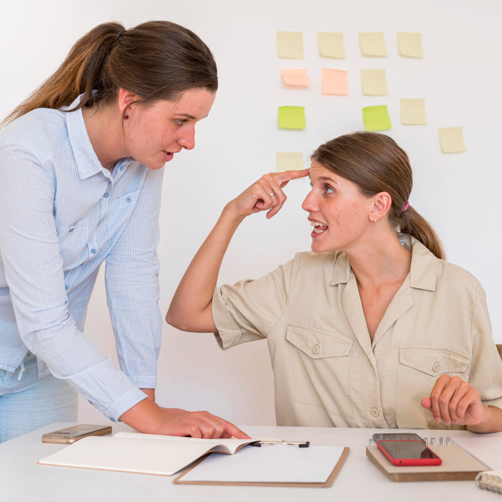 Colaboradoras em ambiente de trabalho discutindo riscos psicossociais previstos na NR1